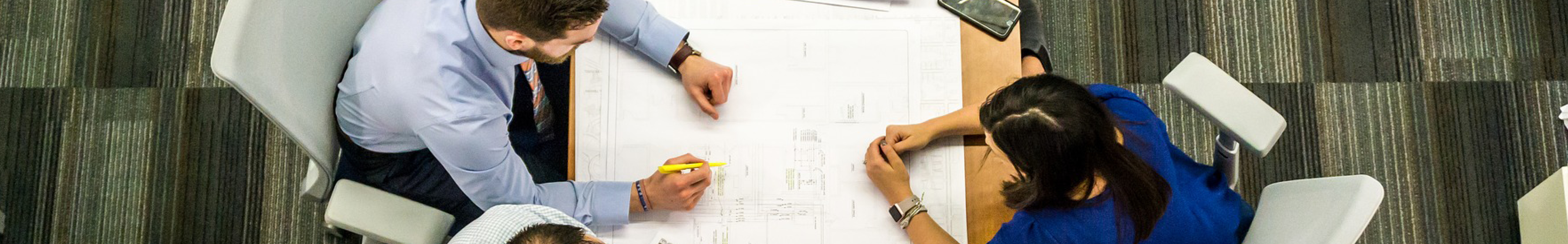 les gens se réunissent à la table avec des plans